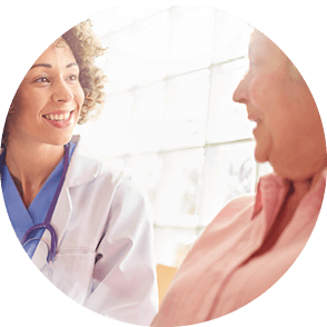 A nurse smiling with a patient